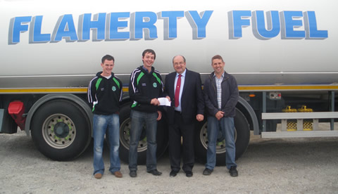 John Mollen (Senior Football Captain) Aidan Doyle (Club Chairman) receiving sponsorship from Brendan Flaherty and David Flaherty